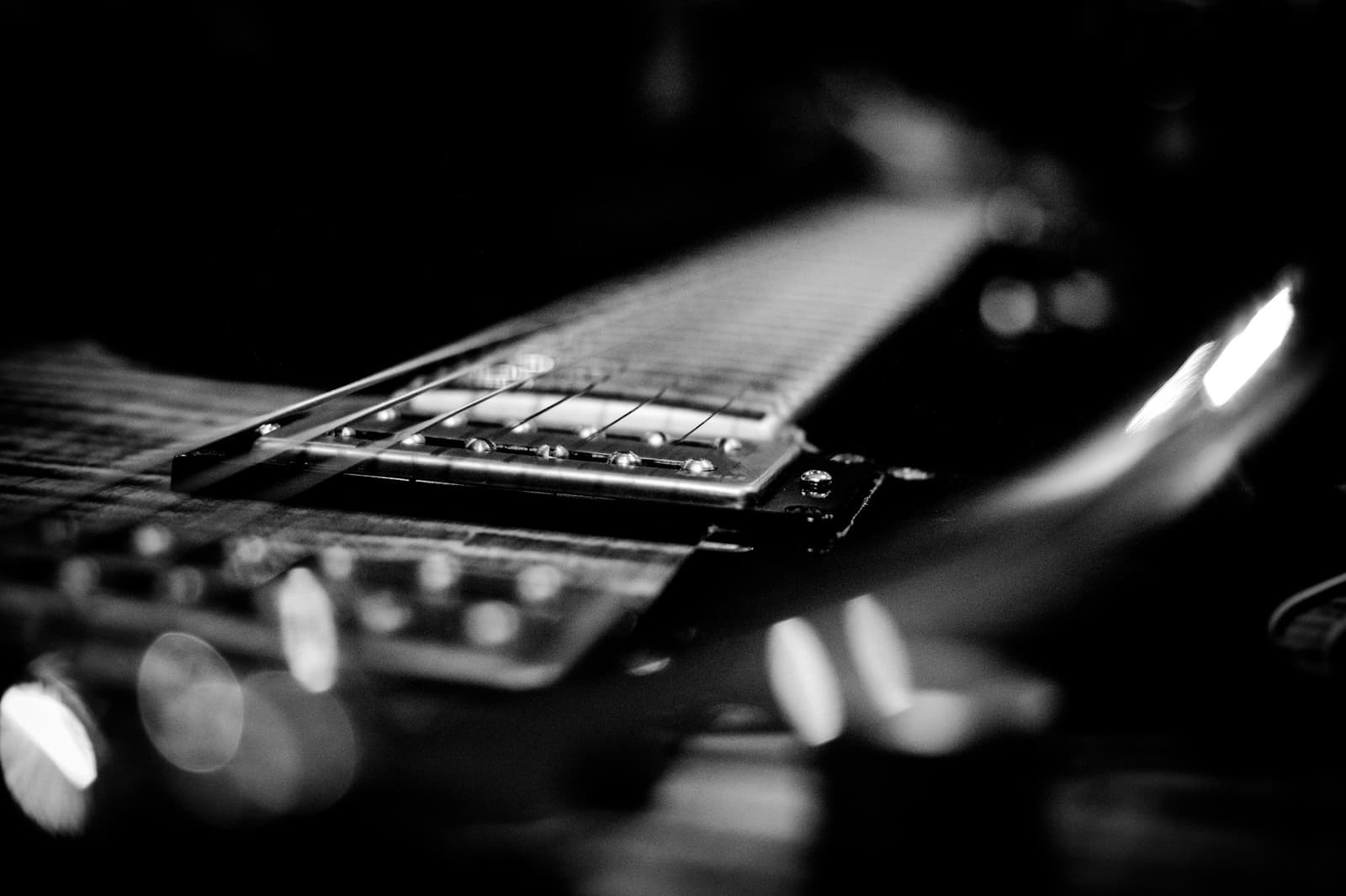 Close-up of the strings and pickup of an electric guitar